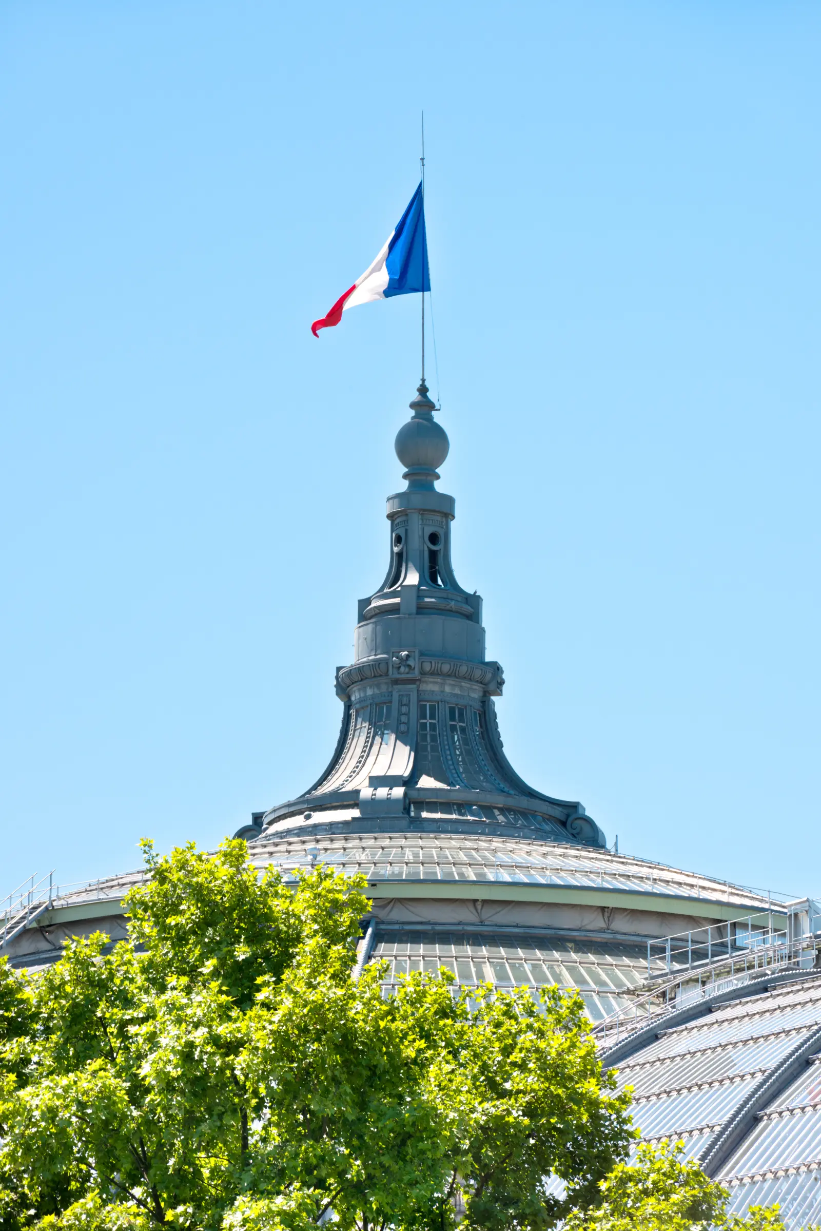 The French flag flying atop a building